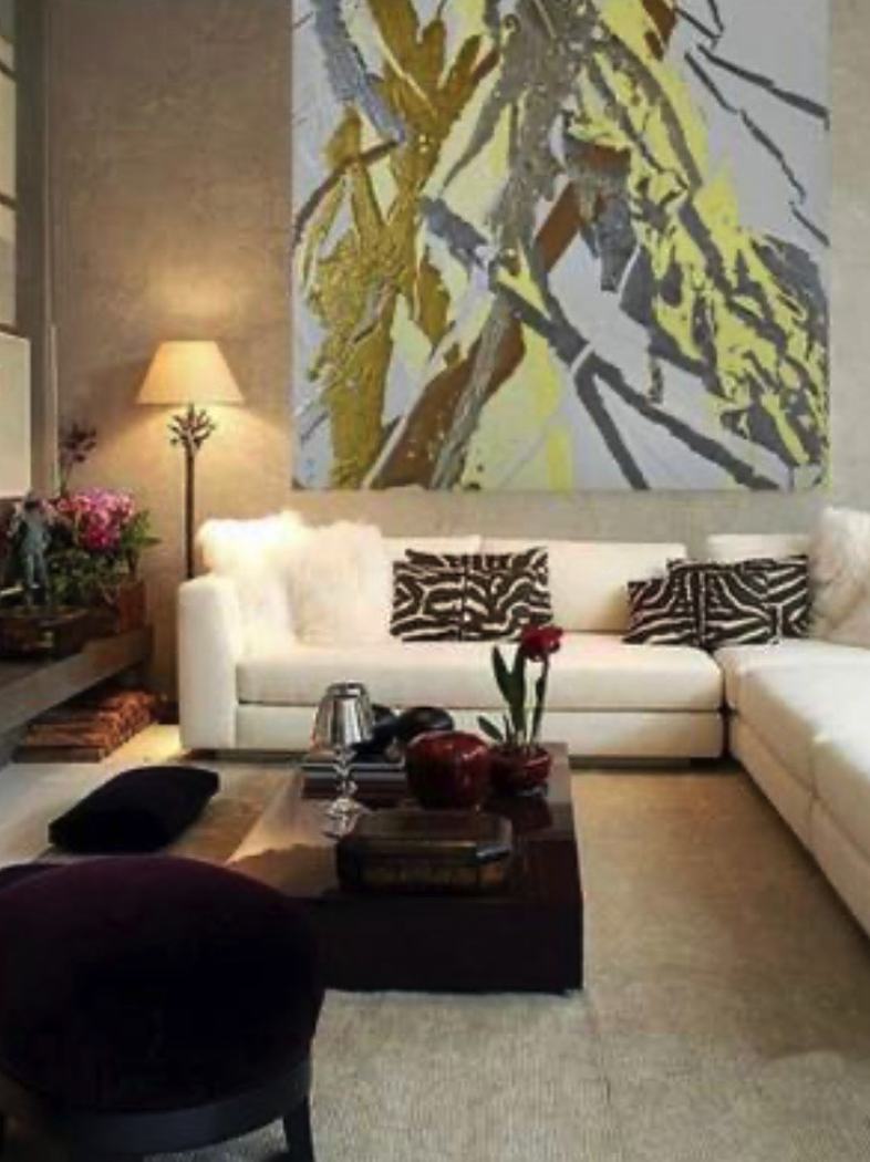 Large abstract painting above a white sofa in a living room