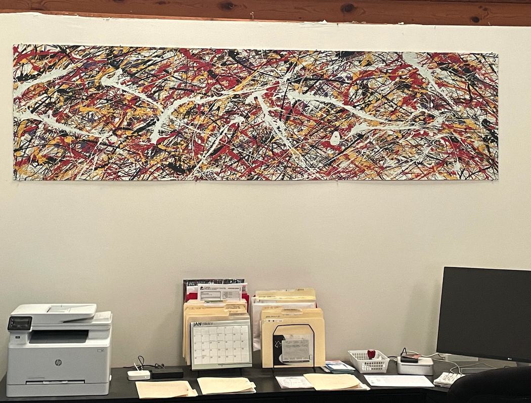Panoramic abstract painting hanging in an office