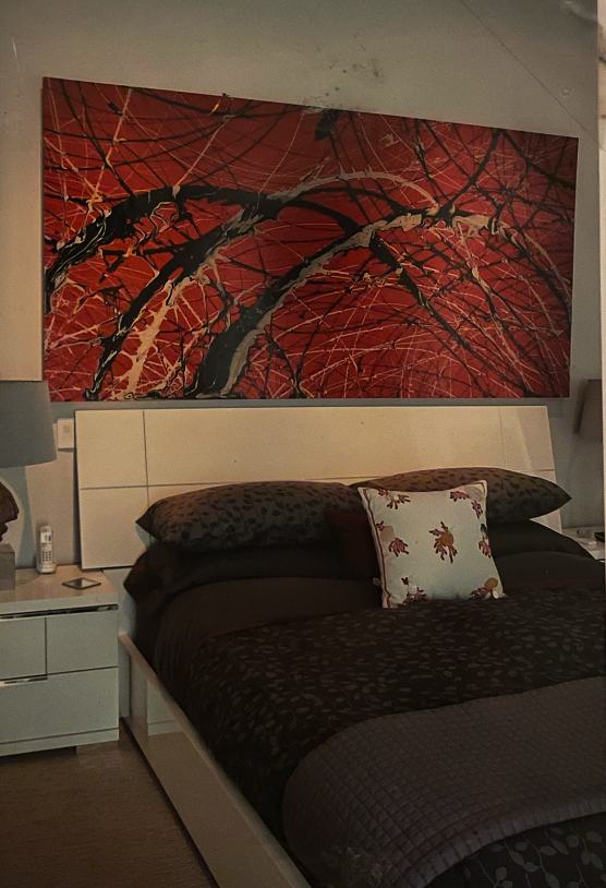 Red abstract painting in a bedroom interior